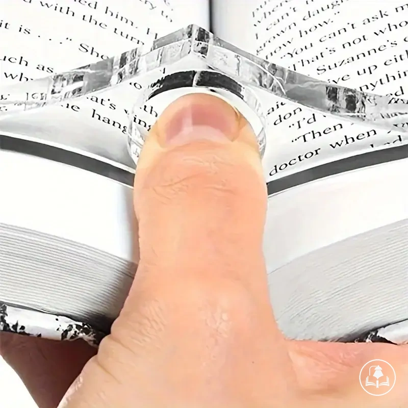 Clear acrylic thumb book holder used to keep pages open while reading